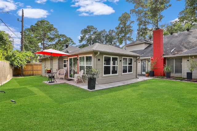 back of property featuring a patio area and a lawn