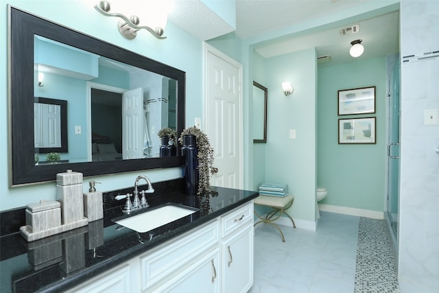 bathroom featuring vanity, an enclosed shower, tile patterned floors, and toilet