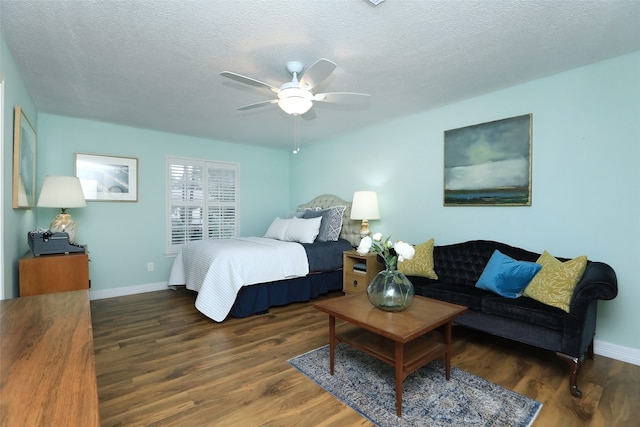 bedroom with dark hardwood / wood-style flooring, a textured ceiling, and ceiling fan