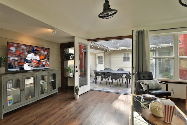 sunroom / solarium featuring track lighting and french doors