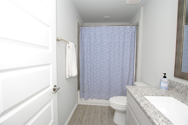 full bathroom featuring vanity, shower / bathtub combination with curtain, and toilet