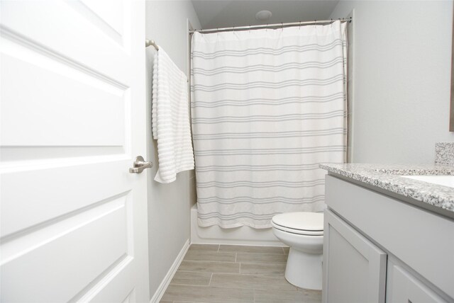 full bathroom featuring shower / tub combo, toilet, and vanity