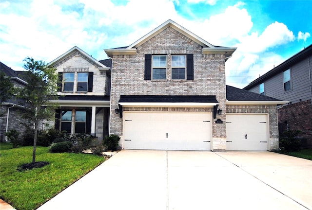 view of front of house featuring a garage and a front yard