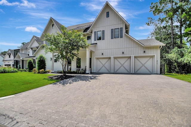 411 N Copa Palm Loop, Montgomery, TX 77316 - modern inspired farmhouse with decorative driveway, board and batten siding, a front yard, and a garage