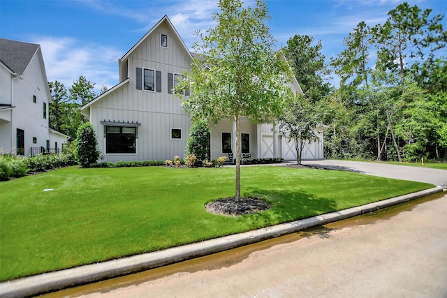 411 N Copa Palm Loop, Montgomery, TX 77316 - modern inspired farmhouse with board and batten siding, a front lawn, and driveway