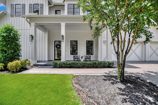 411 N Copa Palm Loop, Montgomery, TX 77316 - doorway to property with a garage, covered porch, a lawn, driveway, and board and batten siding