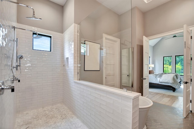 411 N Copa Palm Loop, Montgomery, TX 77316 - ensuite bathroom featuring a ceiling fan, tiled shower, lofted ceiling, and ensuite bathroom