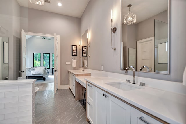 bathroom featuring dual vanity, ceiling fan with notable chandelier, and hardwood / wood-style flooring