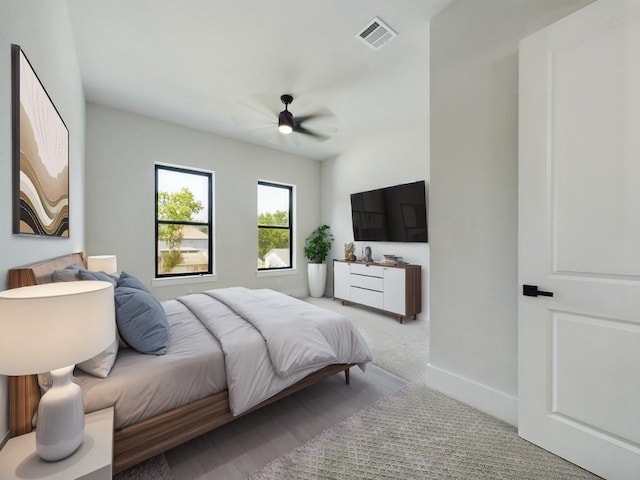 bedroom with visible vents, a ceiling fan, and baseboards