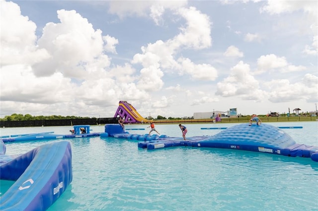 view of pool featuring a water view