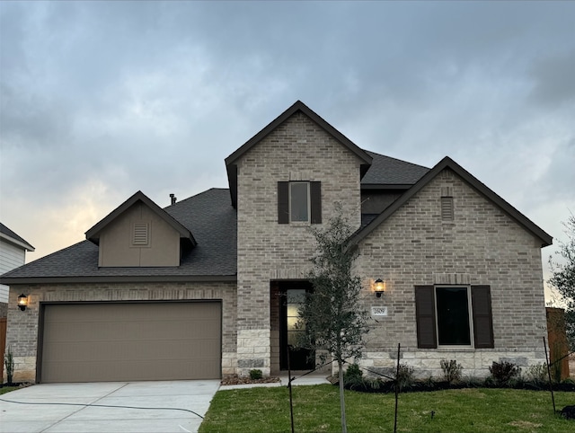 french country style house with a garage and a front lawn