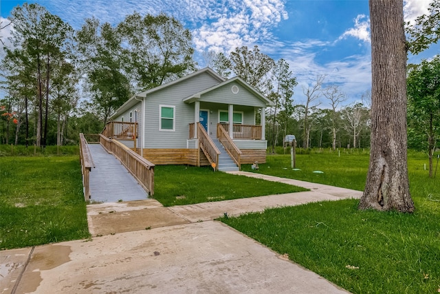 view of front of home with a porch and a front yard