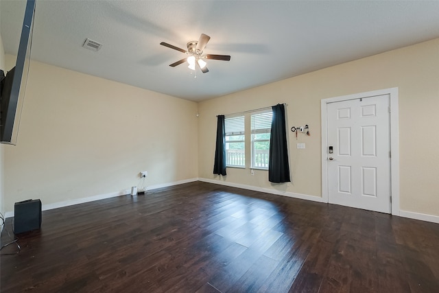 interior space with a textured ceiling, dark hardwood / wood-style floors, and ceiling fan