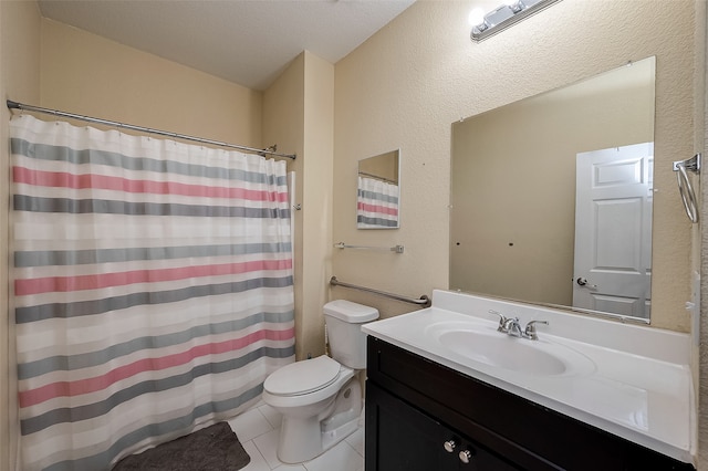 bathroom featuring tile patterned floors, vanity, toilet, and a textured ceiling