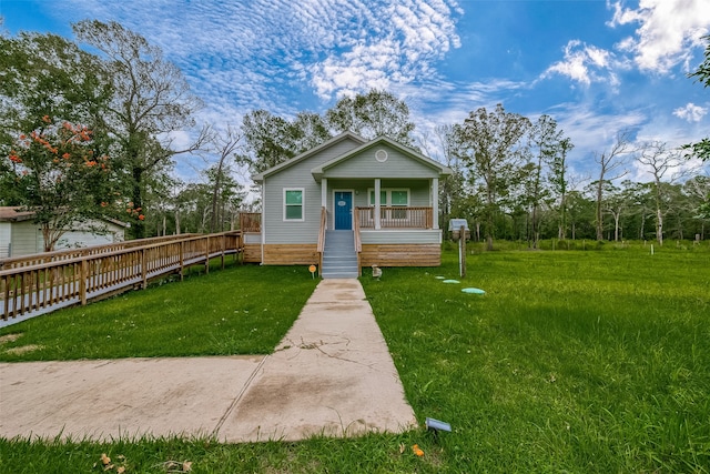 bungalow featuring covered porch and a front lawn