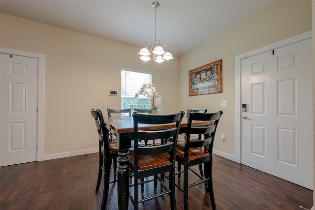 dining room featuring dark hardwood / wood-style floors and an inviting chandelier