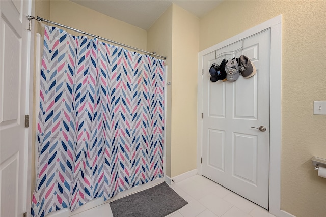 bathroom featuring tile patterned floors and a shower with curtain