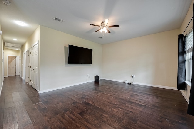 unfurnished living room with ceiling fan and dark wood-type flooring