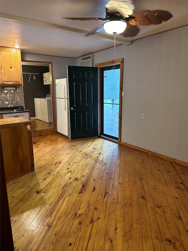 interior space with washing machine and dryer, light brown cabinets, ceiling fan, light hardwood / wood-style flooring, and white refrigerator