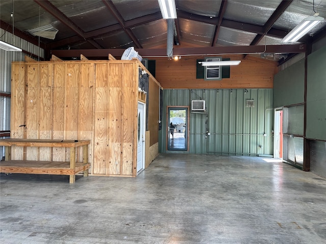 garage featuring wood walls and an AC wall unit