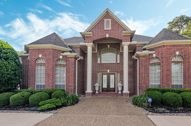 22222 Holly Creek Trl, Tomball, TX 77377 - view of front of house with french doors, brick siding, and a shingled roof