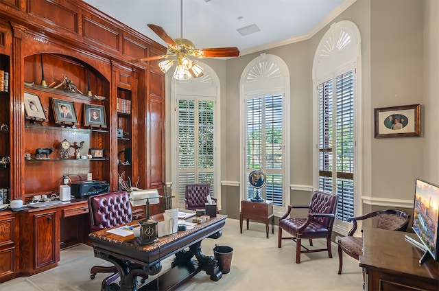 office space with crown molding, light colored carpet, and ceiling fan