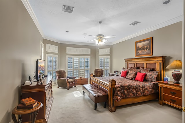 bedroom with ornamental molding, light colored carpet, a textured ceiling, and ceiling fan