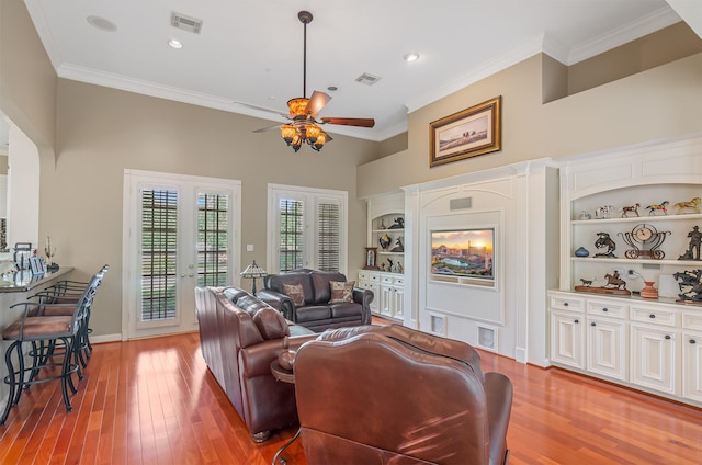 22222 Holly Creek Trl, Tomball, TX 77377 - living area featuring crown molding, ceiling fan, light wood finished floors, french doors, and recessed lighting