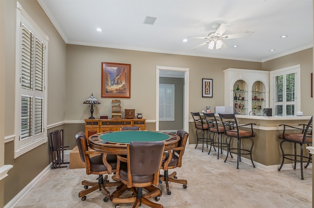 playroom with ceiling fan, bar area, and crown molding