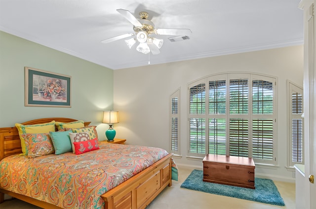 bedroom featuring ceiling fan, light carpet, and crown molding