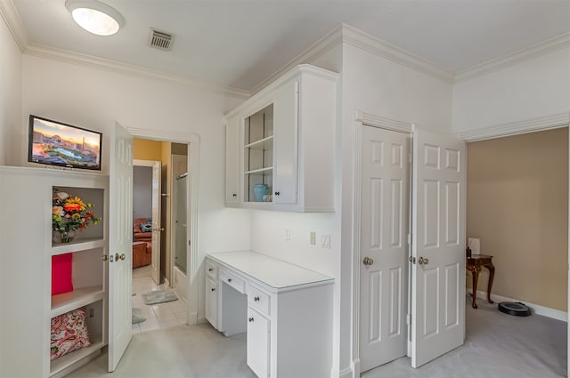 corridor featuring ornamental molding and light tile patterned floors