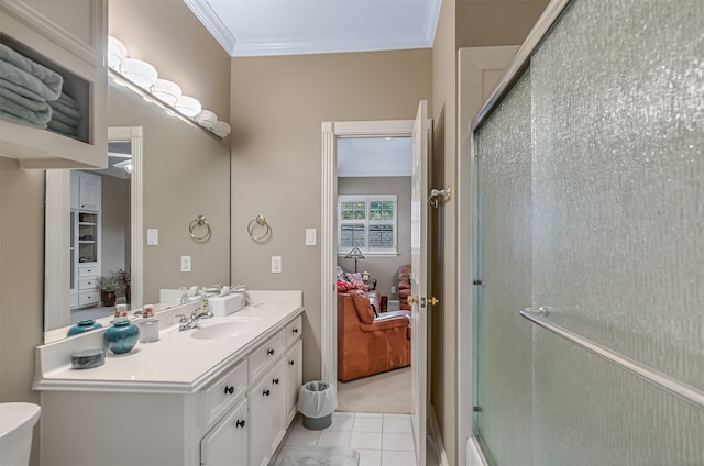 bathroom with tile patterned flooring, toilet, crown molding, a shower with door, and vanity