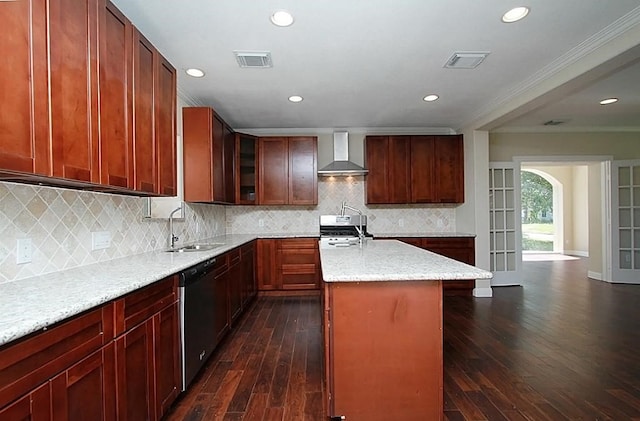 kitchen with dark wood-type flooring, backsplash, wall chimney exhaust hood, stove, and sink