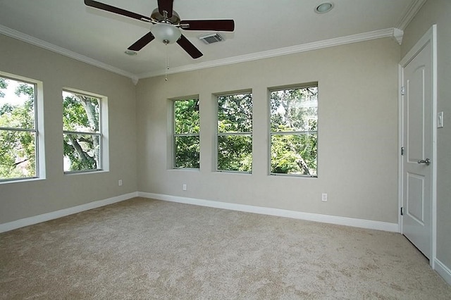 carpeted spare room featuring baseboards, crown molding, and ceiling fan