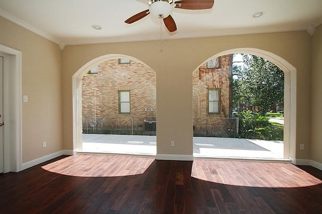 interior space featuring ornamental molding, ceiling fan, wood finished floors, and baseboards