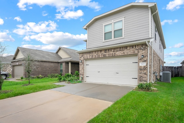 view of front of property with a garage, a front lawn, and central air condition unit