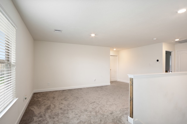 unfurnished room featuring carpet floors and a wealth of natural light