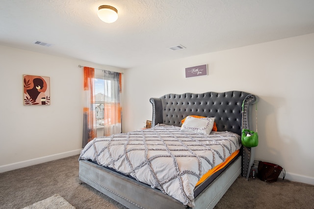 bedroom with carpet and a textured ceiling