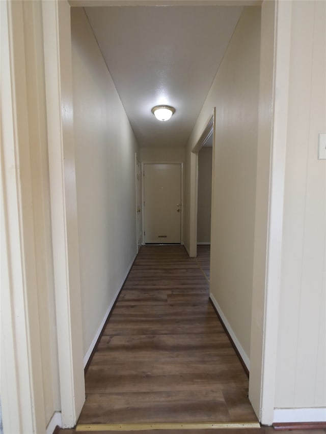 corridor with hardwood / wood-style flooring