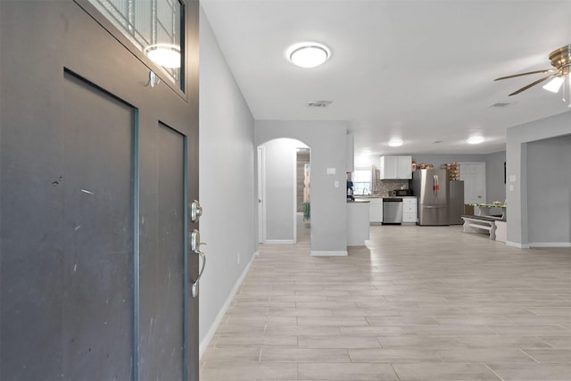 foyer featuring light wood-type flooring and ceiling fan