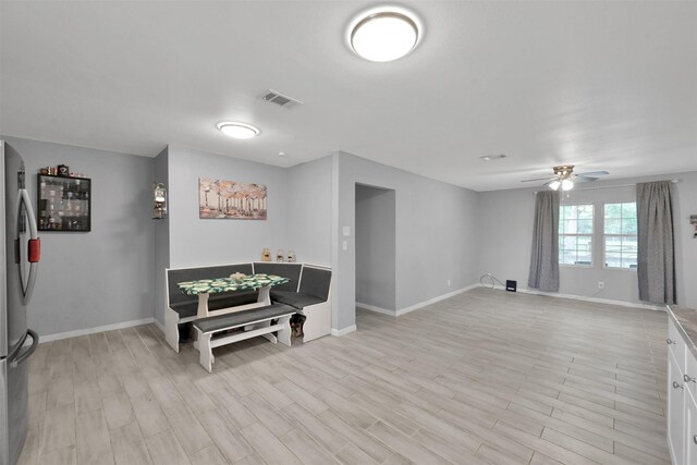 interior space with stainless steel fridge, light wood-type flooring, and ceiling fan