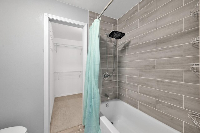 bathroom featuring shower / tub combo with curtain and toilet