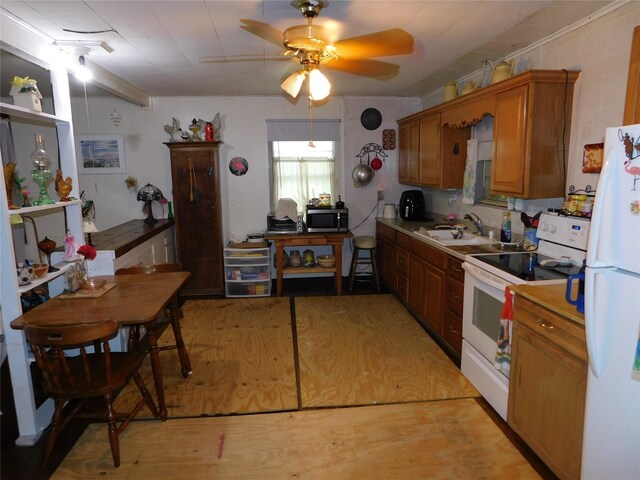 kitchen with sink, white appliances, ceiling fan, and light wood-type flooring