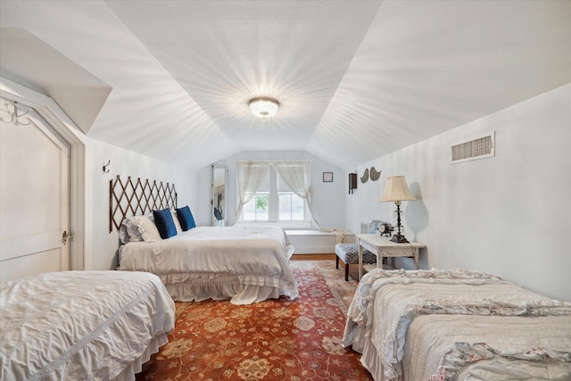 bedroom with wood-type flooring and lofted ceiling