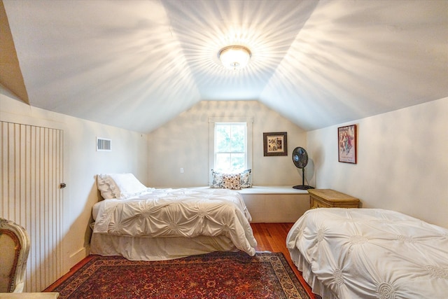 bedroom featuring hardwood / wood-style flooring and lofted ceiling