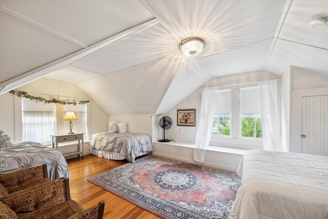 bedroom featuring lofted ceiling and hardwood / wood-style flooring