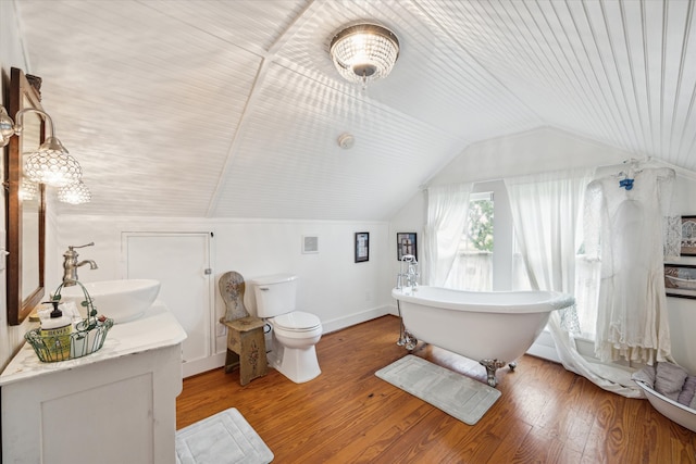 bathroom with vanity, hardwood / wood-style flooring, lofted ceiling, and toilet