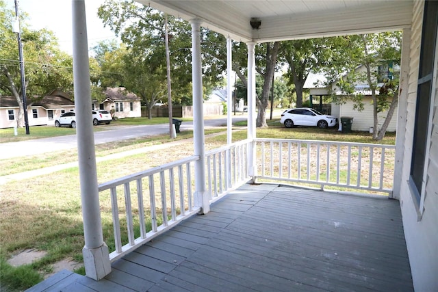 deck with covered porch and a residential view