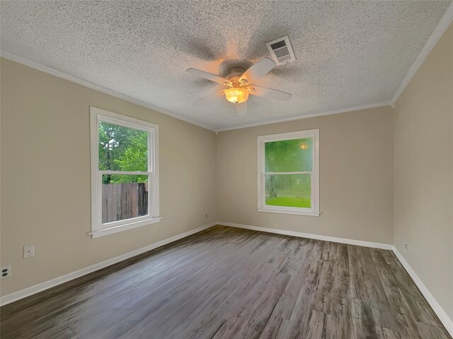 empty room with ceiling fan, hardwood / wood-style flooring, ornamental molding, and a textured ceiling