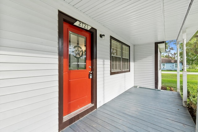 view of exterior entry with a porch